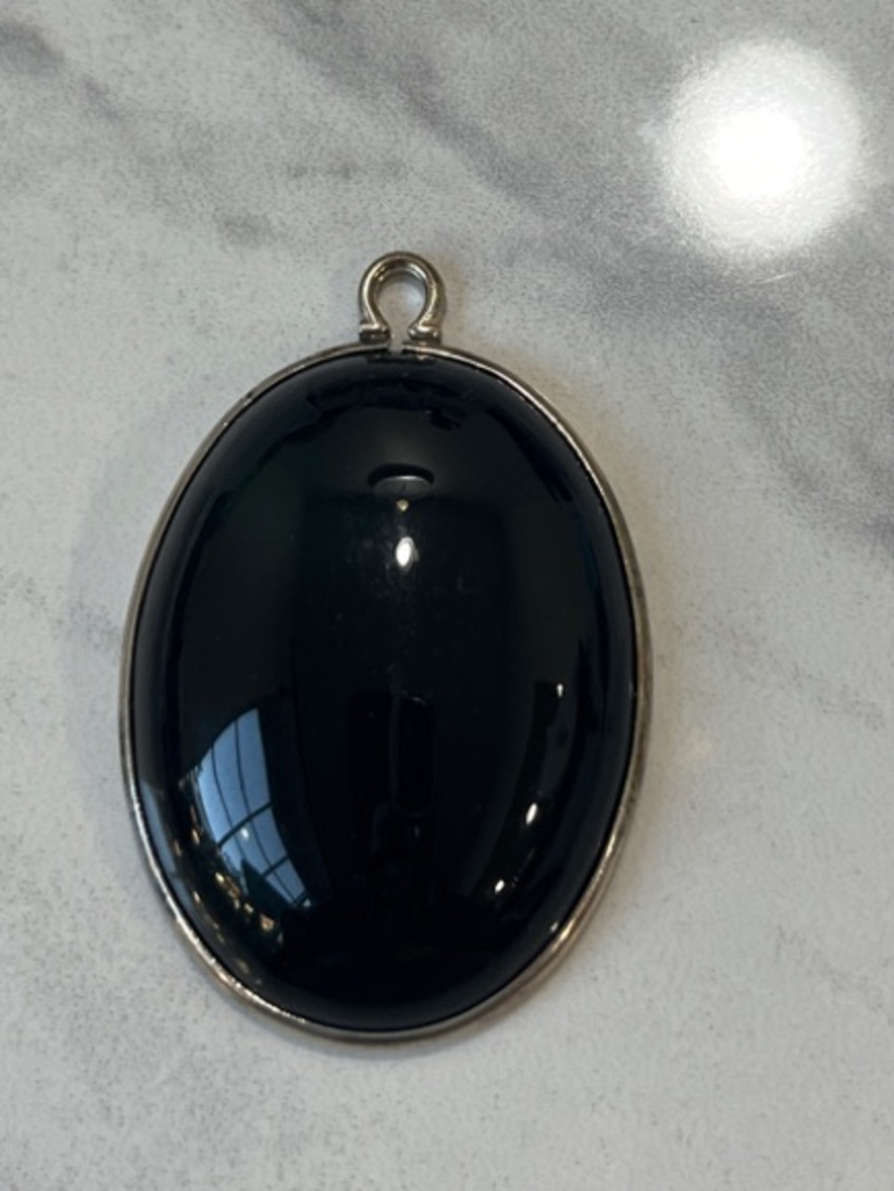 Oval Black Onyx Pendant in Silver Tone Setting